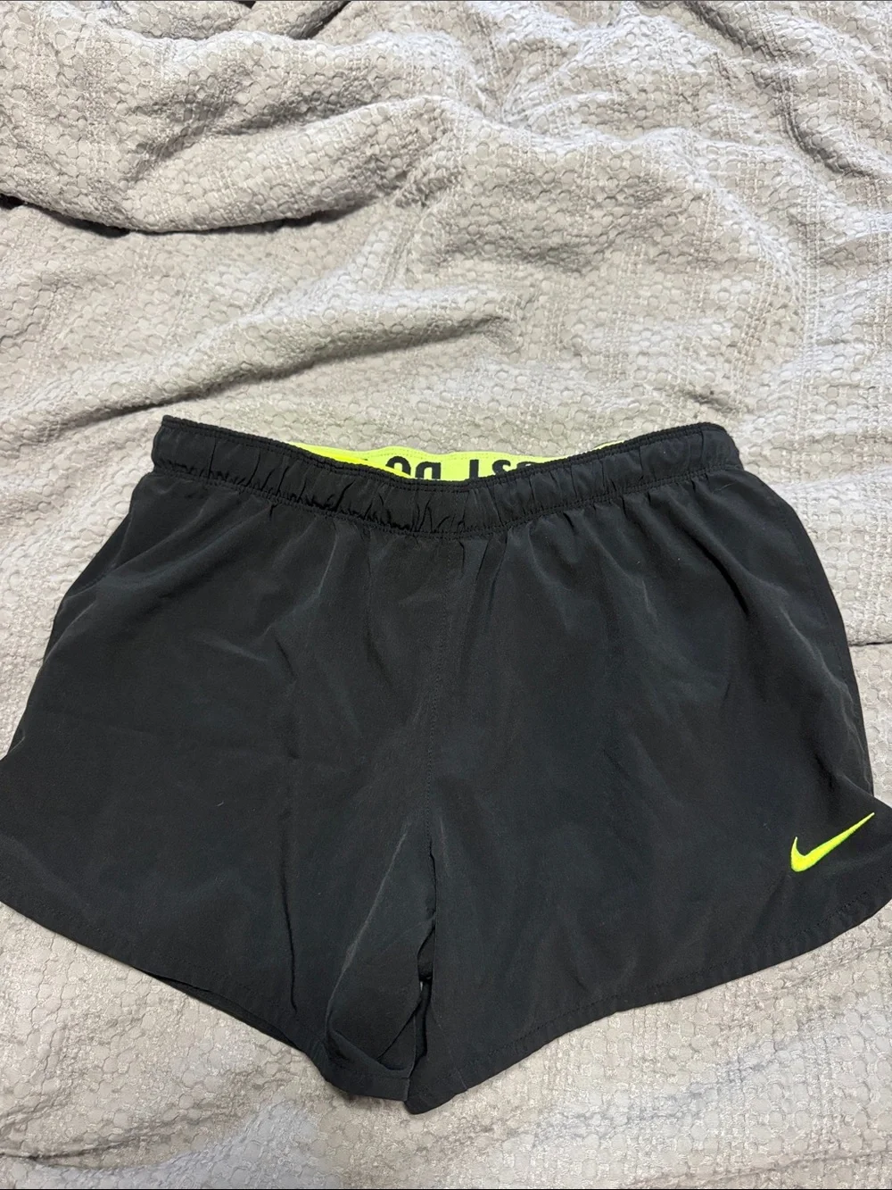 Nike Women's Black Athletic Shorts with Neon Yellow Swoosh